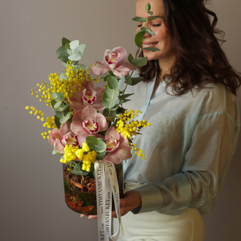 Орхидеи с мимозой и эвкалиптом в стеклянном цилиндре